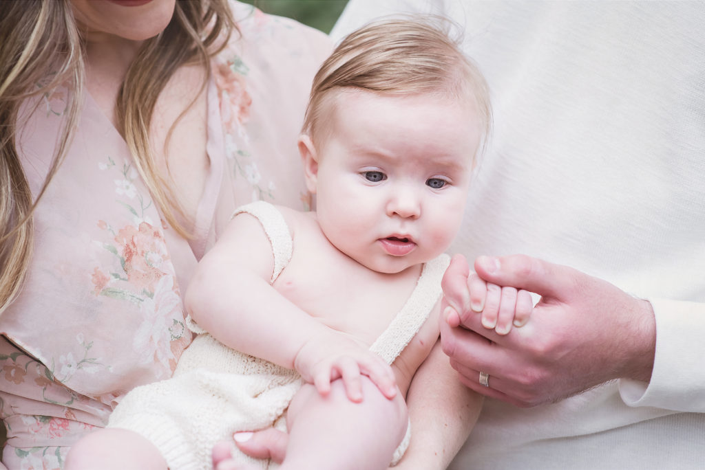 Little baby clutching father's hand by Abbie Franz Photography